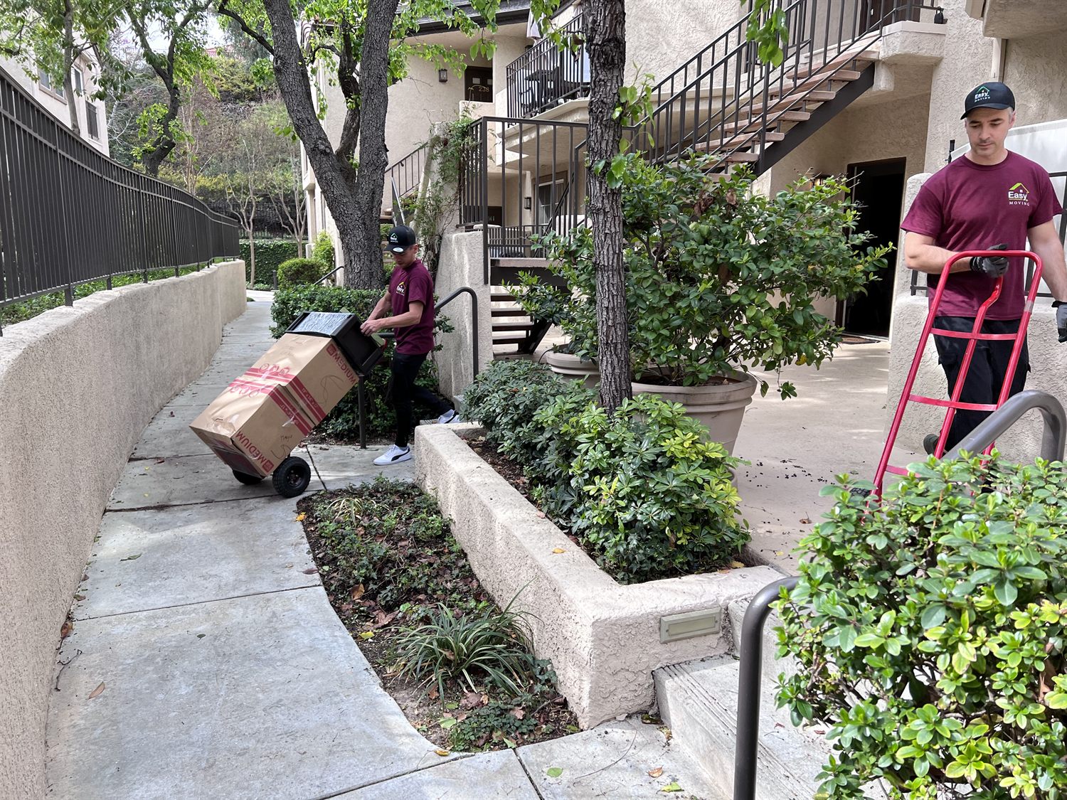 Easy Moving LA movers using dollies at an apartment complex