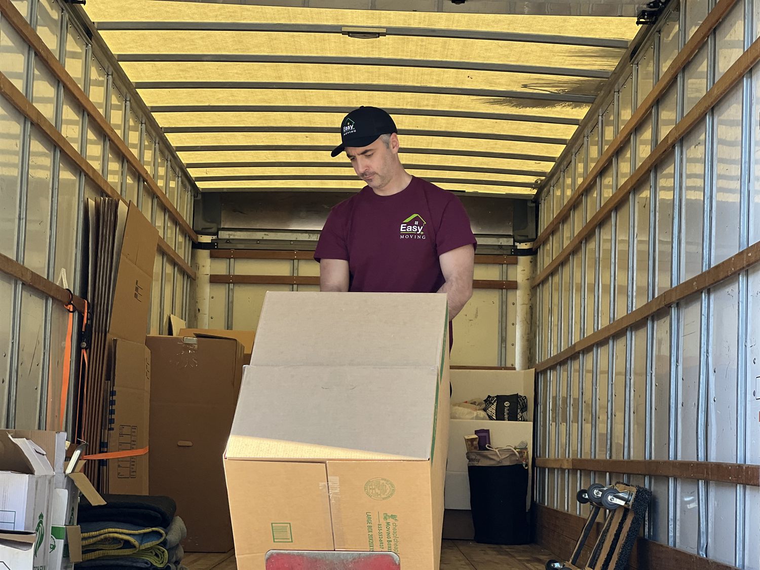 Easy Moving LA mover arranging boxes inside a moving truck